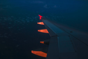 airplane out the window of city at sunset