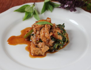spicy chicken with basil thai food on plate