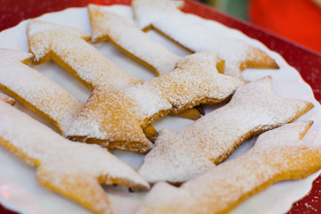 many cookies in the form of arrows on a plate