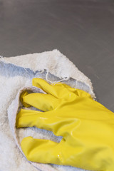 The hand in the protective glove wipes the hood