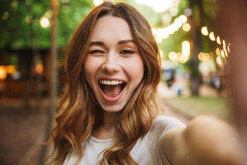 Close up of happy young girl taking a selfie