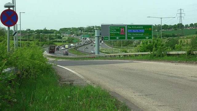 A time lapse of road traffic joining the A14 dual carriageway road at Kettering in Northamptonshire in England.