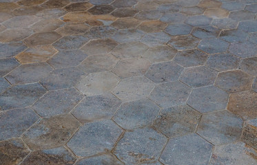 Perspective view on gray paving stones. Street floor made with hexagon shaped concrete plates