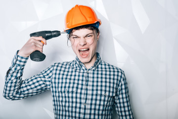 Worker, repairer, repairman, strong builder on thoughtful face carries toolbox on shoulder, ready to work. Man in helmet, hard hat holds toolbox, blue background. Repair and renovation concept.