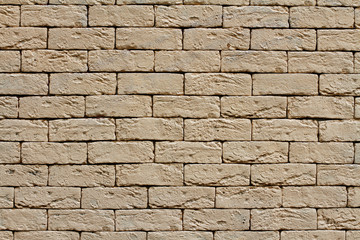 Yellow rough brick wall as background, texture