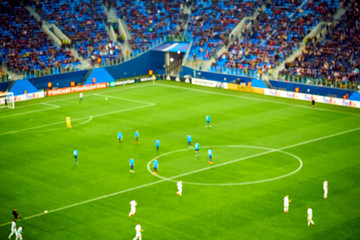 Soccer players at the pitch. Blurred soccer game view from tribunes - 207935020