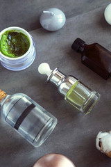 SPA cosmetic products on dark table from above. Coconut, argan oils, organic creams and serums. Beauty blog flatlay
