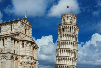 Fototapeta na wymiar Square of Miracles landmarks: Pisa Cathedral and the famous Leaning Tower, among beautiful clouds. Unesco Wolrld Heritage
