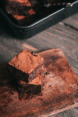 Decadent moist dark chocolate stout beer brownies cut in squares. Dark food photography concept