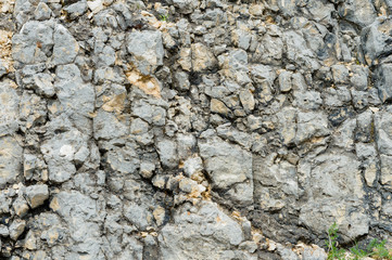Textured stone background Rubble ballast in natural form in the rock wall