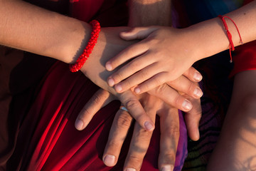 hands of a man, woman, child together