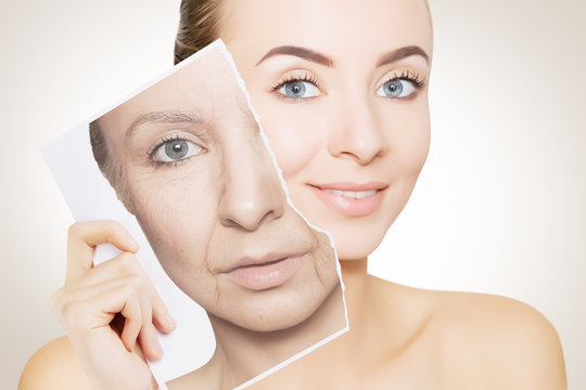 portrait of young woman face holding portrait with old wrinkled face