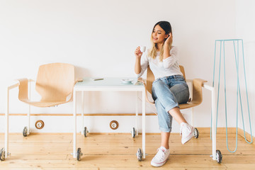 Young hispanic woman at cafe drinking coffee  