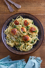 Spaghetti with spinach and chicken meatballs. Pasta with meatballs. View from above, top studio shot