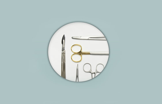 Surgical instruments in white circel in the center of a light blue background