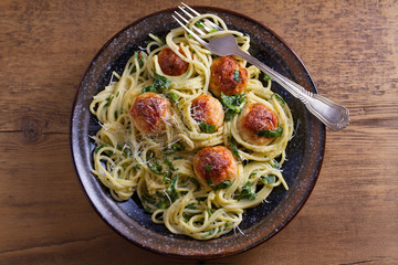 Spaghetti with spinach and chicken meatballs. Pasta with meatballs. View from above, top studio shot