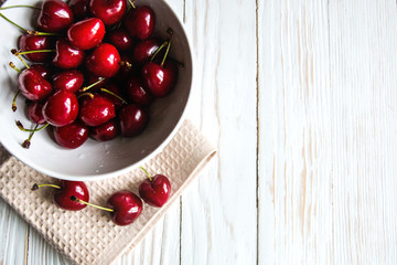 delicious ripe cherry on white wooden background top view