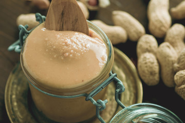 Peanut Butter in Glass Jar as Healthy Breakfast. Vegetarian Food Concept.
