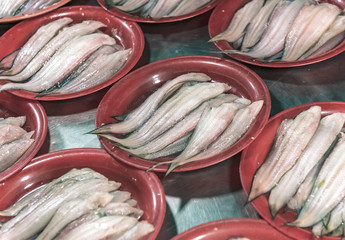 Fresh fish filts in red plates.