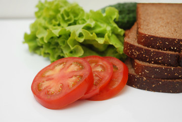 Vegetables, Ingredients for Vegan Sandwich Cucumber, tomatoes, Salad Leaves, Bread