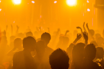 blurred light in night club party festival with crowd of people for background;