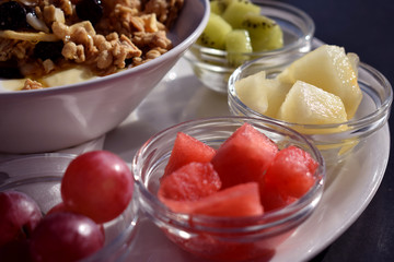 Healthy morning breakfast with fruit and muesli in a cafe with a sea view