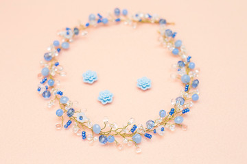 A small and simple decoration of the bride. Cornflower blue and white bell color. Hair decoration on a beige felt.