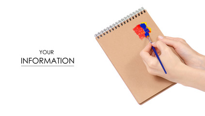 Notepad for drawing and paint brush in hand pattern on white background isolation
