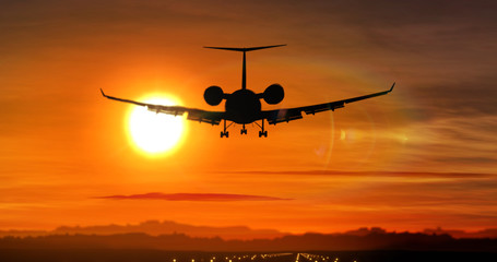 Naklejka na ściany i meble Airplane landing - private jet silhouette on sunset