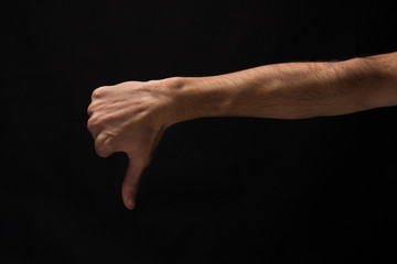 Thumb down sign isolated on black background