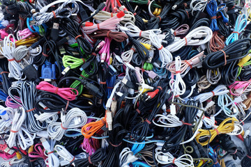 Pile of colorful many used Cable cord Chargers, Wires Plug and USB,Texture background. for Reuse...