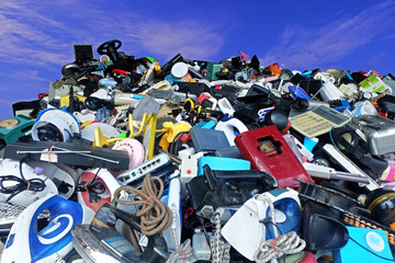 Pile of used Electronic and Housewares Waste Division broken or damage with blue sky and clouds background,  for Reuse and Recycle concept.