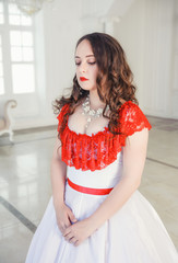 Beautiful woman in medieval dress with crinoline in the hall