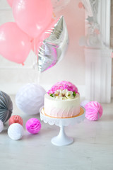 Decorations for birthday party. A lot of balloons pink and white colors. Cake for holiday party. 