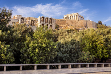 Fototapeta na wymiar Greece, Athens, Areopagus: People residents toruists visit famous Acropolis with green park trees, horizon and blue clear sky background in the city center of the Greek capital. April 25, 2018