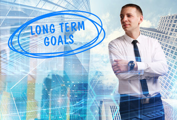 The concept of business, technology, the Internet and the network. Young businessman showing inscription: Long term goals