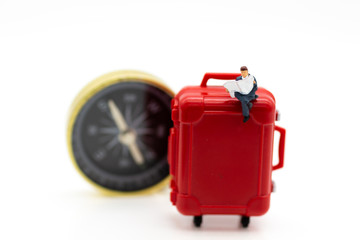 Miniature people : Travelers with red suitcase and compass. Image use for travel, business concept.