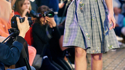 Closeup of photographers working on presentation of modern fashion show