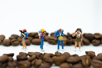 Miniature people: Traveler figure toy with coffee bean . Image use for background travel and food concept.