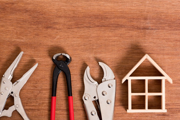 wood house skeleton with tool for fix problem on wood background