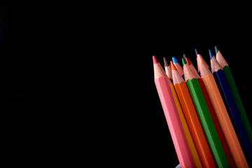 Fototapeta premium Colour pencils isolated on black background close up