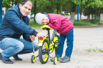 dad's repairing the Bicycle outdoors