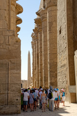 Tourist excursion in the large hypostyle hall of the temple in Karnak. Luxor, Egypt