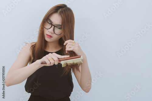 Portrait Of Asian Woman Long Hair With A Comb And Problem Hair On