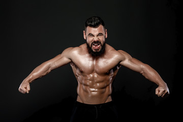 Fototapeta na wymiar Handsome strong bodybuilder posing in studio