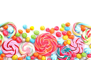 Fototapeta na wymiar Multicolored lollipops and round candies on a white background. Top view. Isolated.
