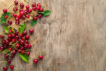 Fresh sweet cherries on wooden background. Top view. Copy space. Flatlay