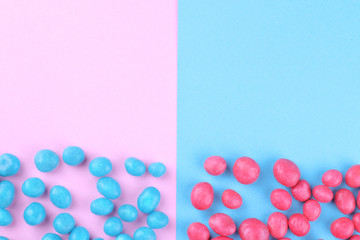 Multicolored round candy on a pink and blue bright background. Top view