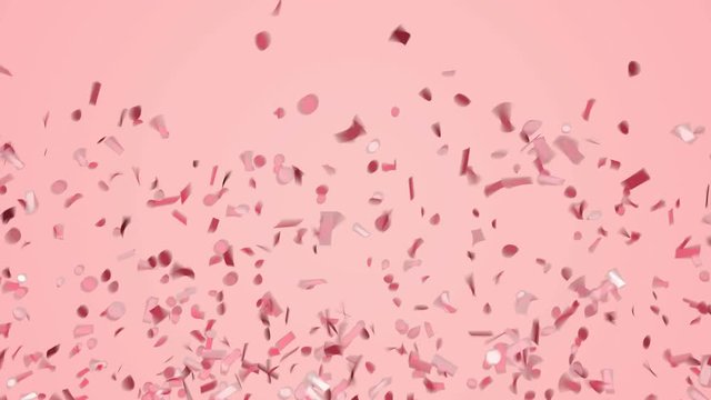 Abstract red or rose gold confetti falling on pastel pink background.