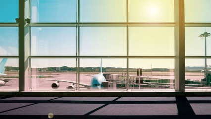 Walkway and glass curtain wall with Airplane background at Airport terminal, Travel concept with copy space. Silhouette background